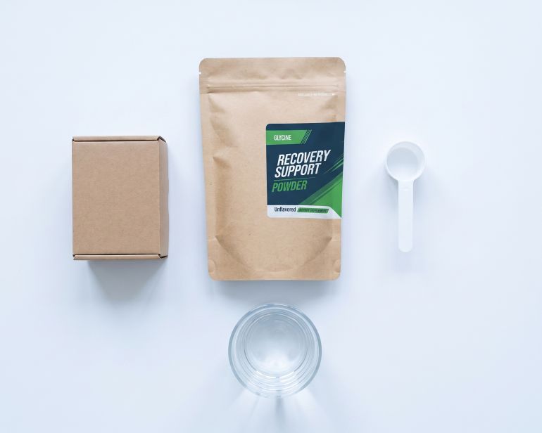 Scientific Blends product with scoop and water